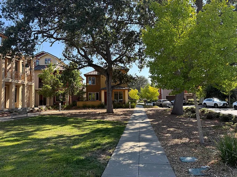 Landscaped front yard and covered porch welcomes you to this charming home situated in a prime location overlooking the community green belt.