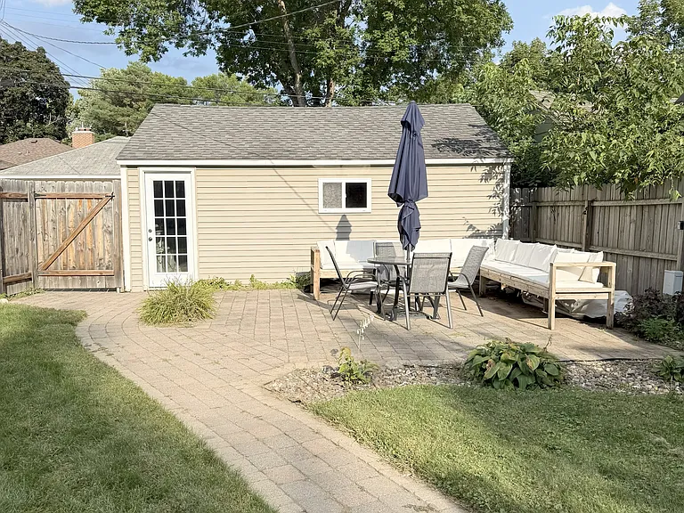 Large fenced-in backyard perfect for pets, children, or entertaining friends and family.