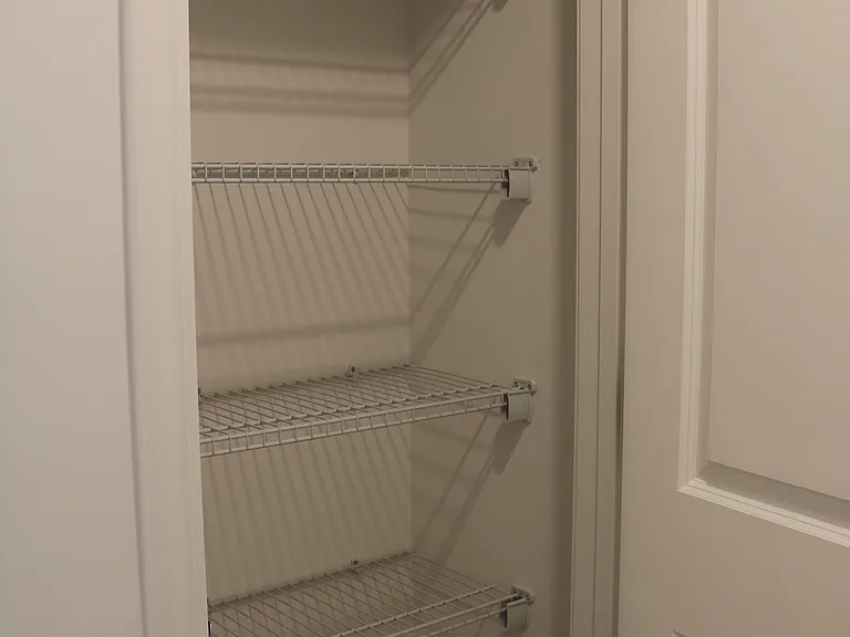 Linen closet next to laundry room