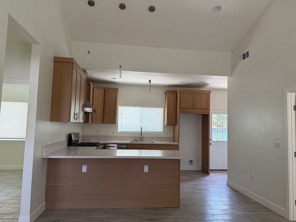 Kitchen features:
1. Light Kitchen Island Modern Linear LED Pendant
2. Gas stove
3. Heavy duty and quiet hood range
4. Refrigerator with water line ready