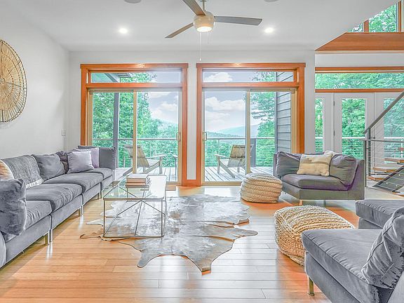 Living room with huge south facing sliders opening onto the deck and the view.