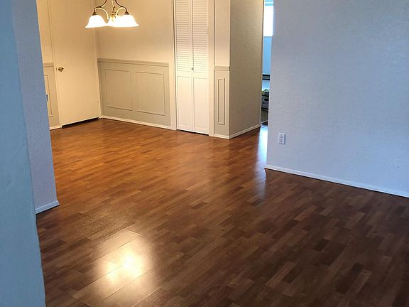 view from front door - living and dining with two closets (doors in photo)