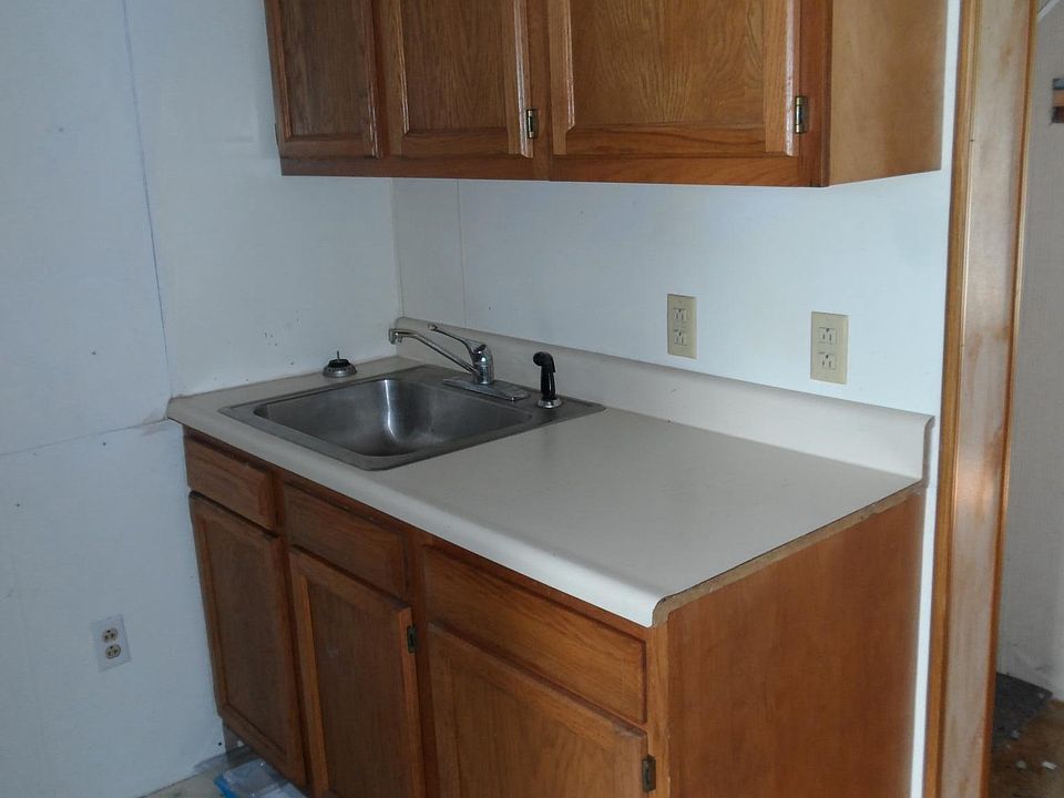 Kitchen with space for washer / dryer, stove, and fridge.