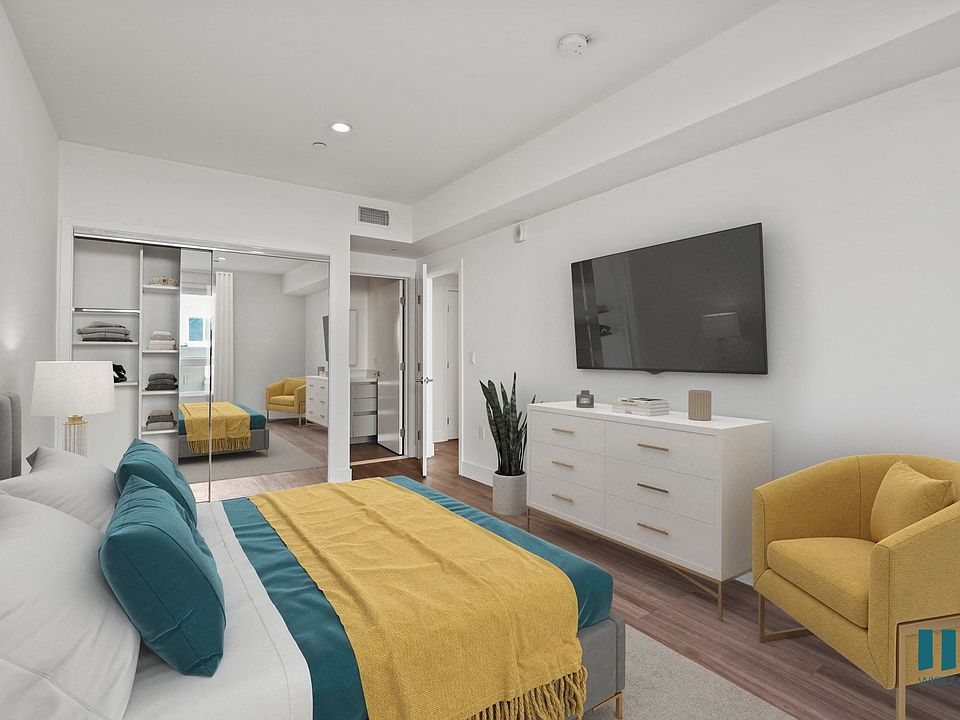 Bedroom with Mirrored Closet with Shelving, Bathroom, and Vinyl Flooring