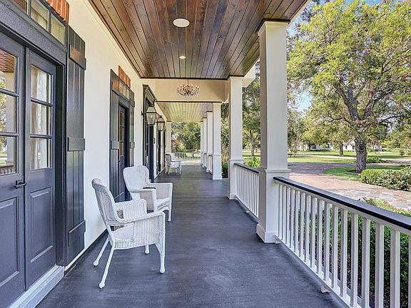 This Acadian style front porch is reminiscent of a time when neighbors sat on the front porch with iced tea and mint juleps. There are 11 Pecan Trees that are over 100 years old. There is landscape lighting throughout the entire property so you can e