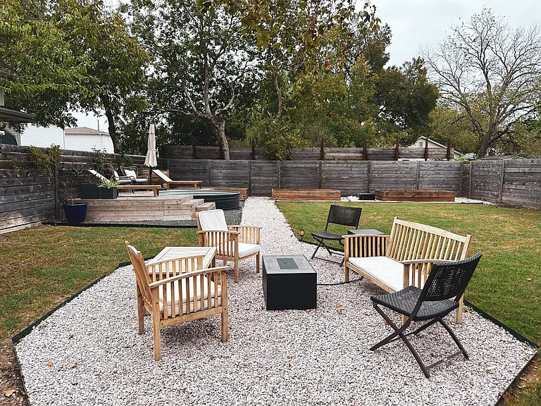 Stock tank pool and backyard area With garden beds