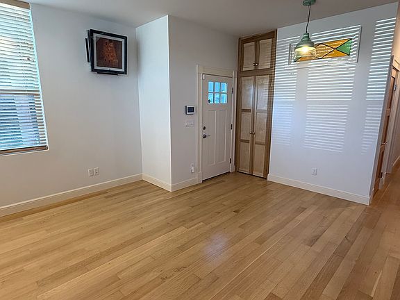 Entrance to open living room and kitchen. Stained glass accentuates a first floor powder room.