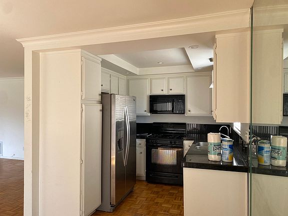 Kitchen with new Fridge, stove/range, built-in microwave, dishwasher, water purifier.