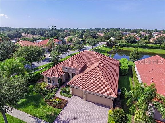 Beautifully landscaped lot with paver driveway and oversized 3 car garage