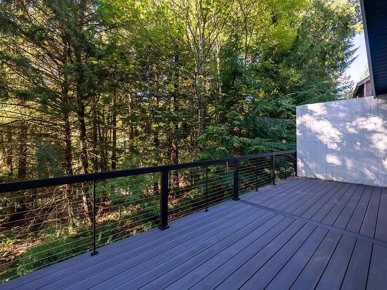 Brand new composite deck & metal railing is easy to keep clean. Privacy wall to keep private from neighbors