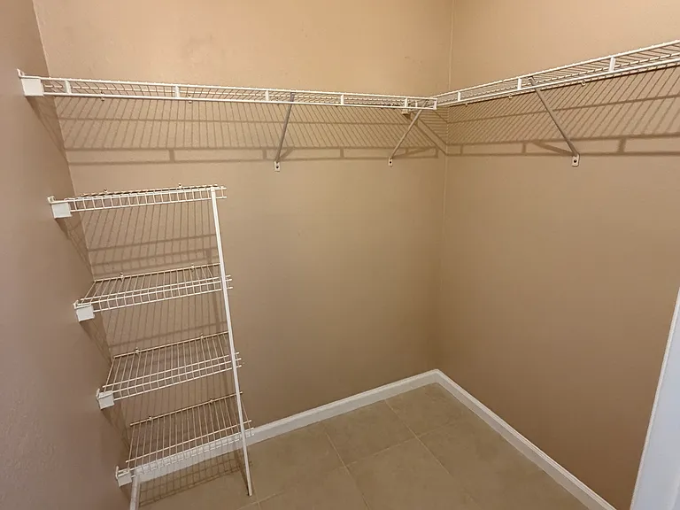 Large master walk-in closet with built-in racks for shoes and clothes