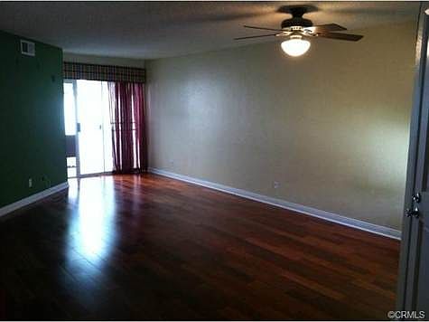 Large family room has hardwood floors and sliding glass door