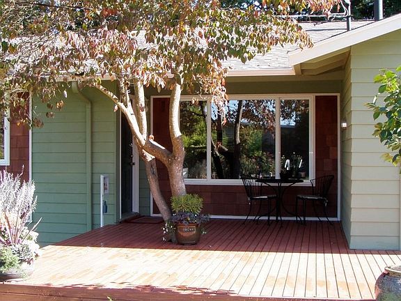 Front sun porch with mature pink dogwood tree