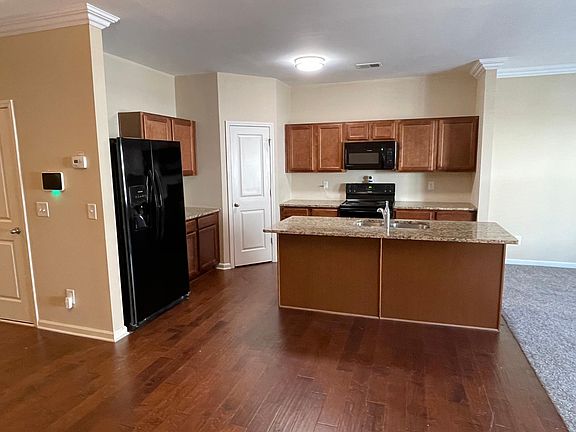 Large kitchen with granite countertops, black energy efficient appliances, including oven, range, microwave, dishwasher, garbage disposal, two door refrigerator which includes ice maker, and a large walk-in pantry!