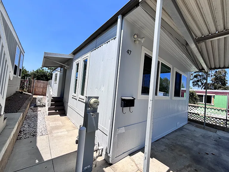 The exterior of this well-maintained mobile home offers both charm and functionality. Featuring durable siding and a clean, inviting facade, the home presents excellent curb appeal.