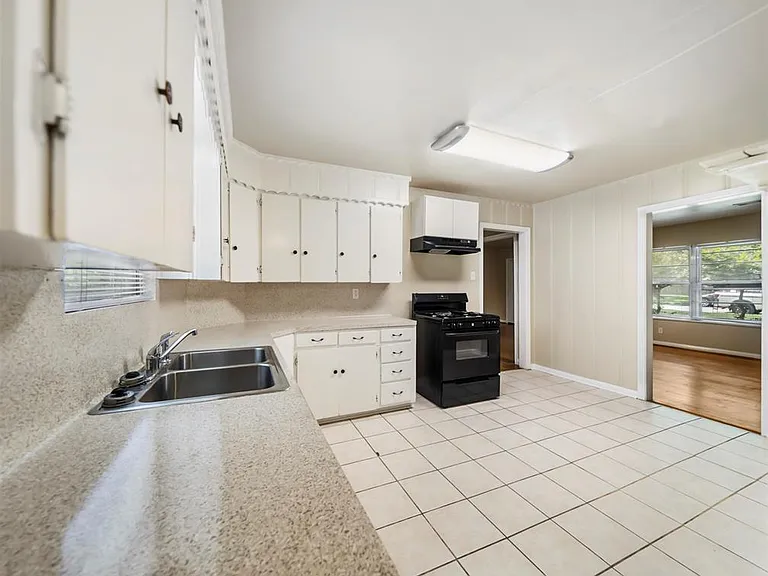 Large eat-in kitchen with black appliances.