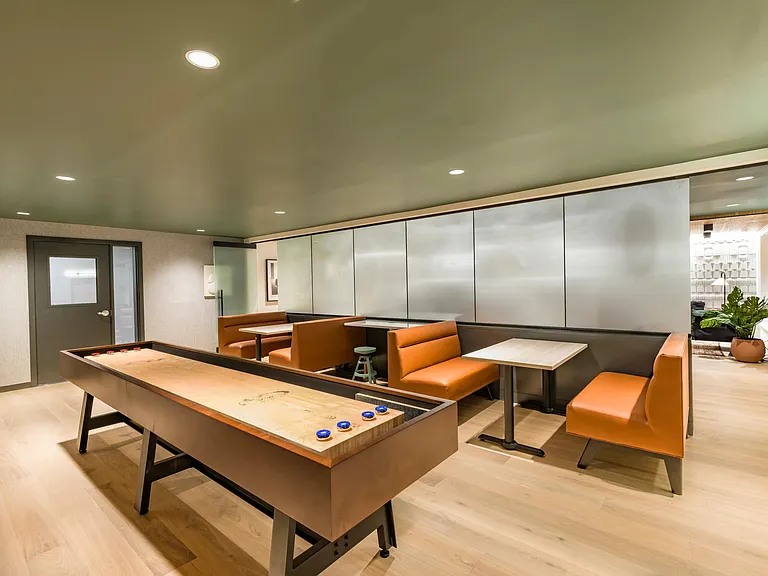 Game on! Modera Woodstock's game room lounge is packed with wall-mounted TVs, game tables, and a multimedia tech room, perfect for a night of fun and relaxation.