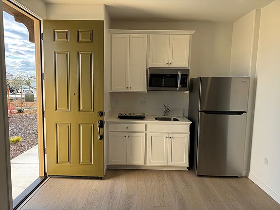 Stainless Steel fridge, microwave and two burner cooktop included
