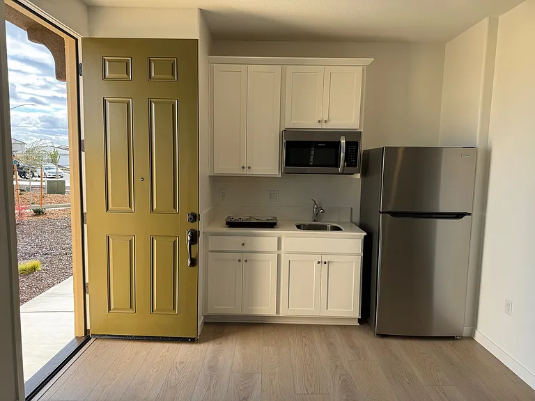 Stainless Steel fridge, microwave and two burner cooktop included