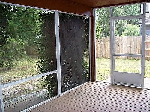 back patio with two side door entrance. Exit from house through sliding glass door