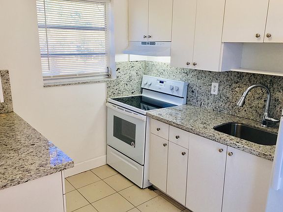 New granite countertops and appliances, well lit with natural light and a doorway leading into the backyard. Adjacent laundryroom availble outdoors.