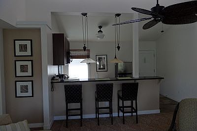 Raised bar area by kitchen is additional dining area