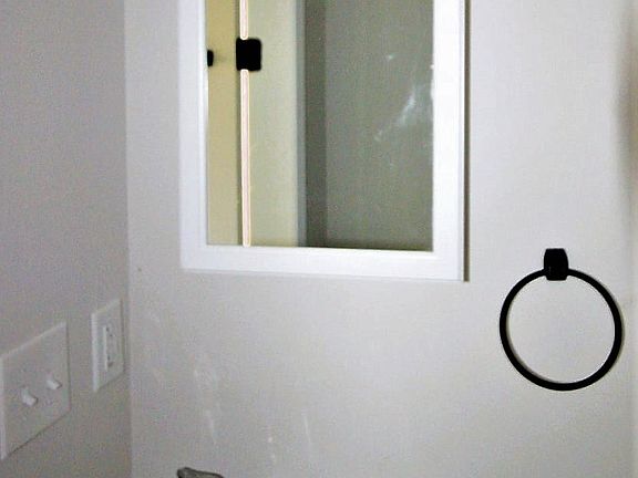 Bright, modern well lit bathroom with shower and tub.