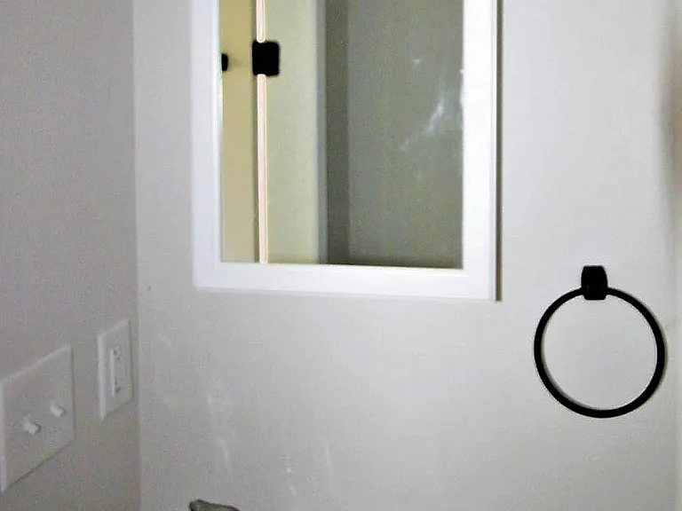 Bright, modern well lit bathroom with shower and tub.
