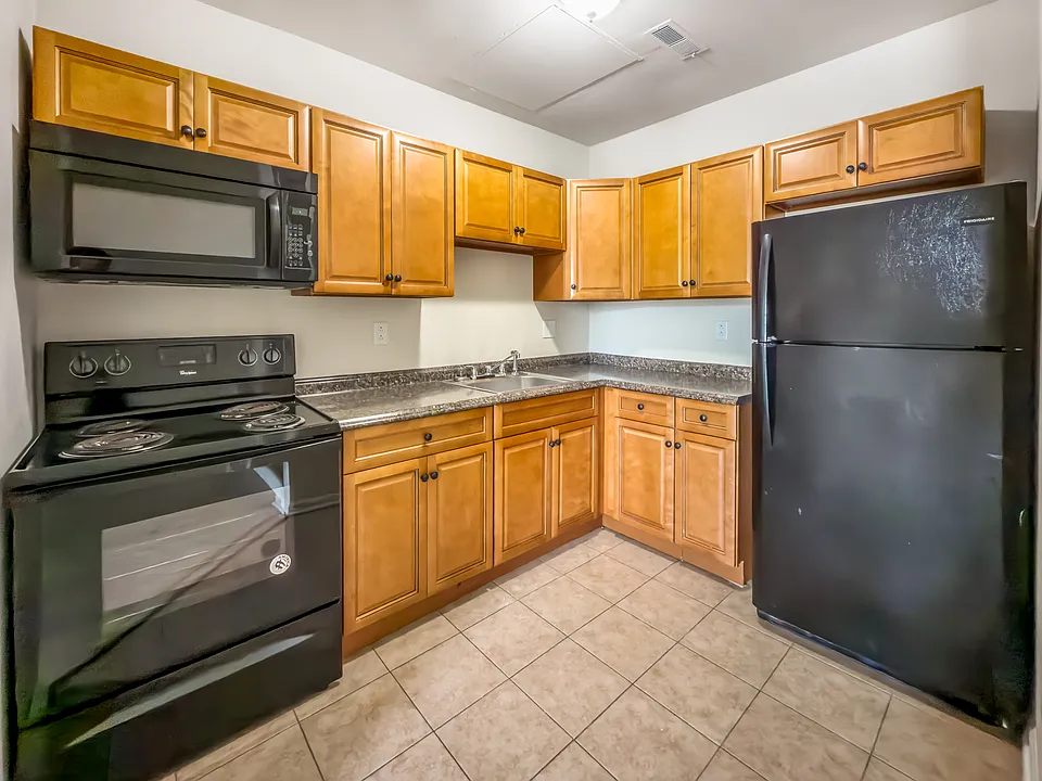 Kitchen featuring back appliances.