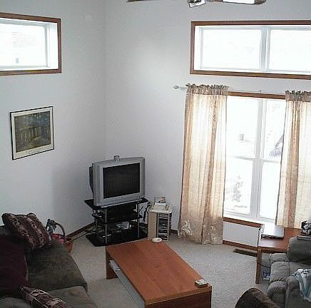 Soaring ceilings with high windows fill the living space with light.