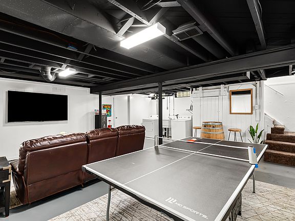 The ping pong table is the perfect way to challenge your friends or family to a game, and the couch is the perfect place to relax and watch the game.