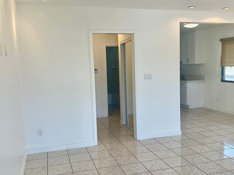 Living room with recessed lighting, tile flooring throughout