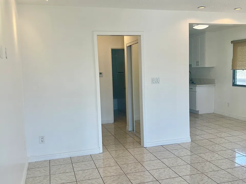 Living room with recessed lighting, tile flooring throughout