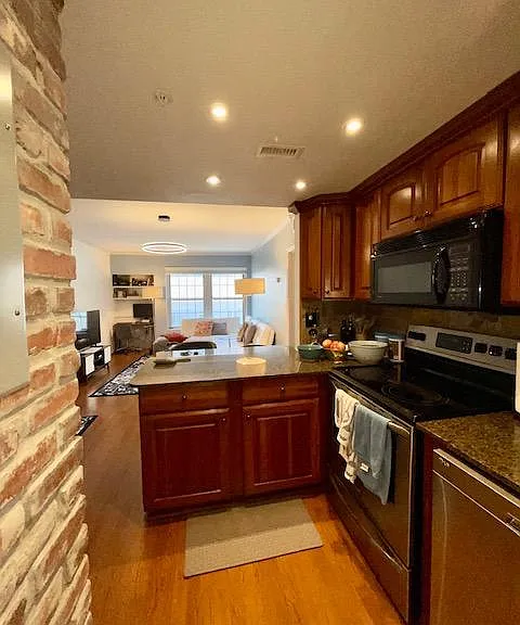 Exposed brick in kitchen. View from kitchen to living room