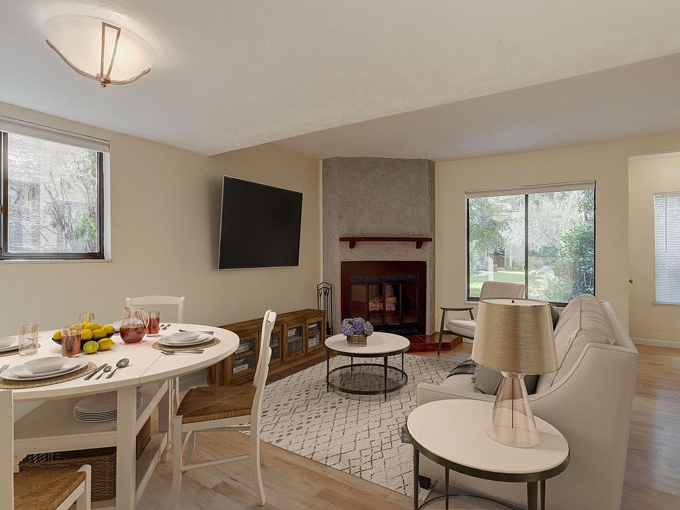 Virtually staged living room - Traditional log fireplace - Southeast facing corner unit with two extra east facing windows