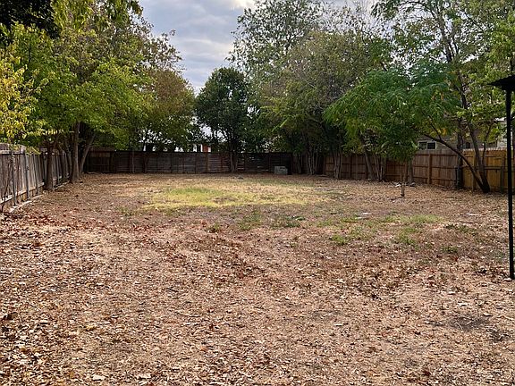 Huge backyard with trees