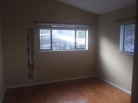 Spacious bedroom with hardwood floors and plenty of natural light
