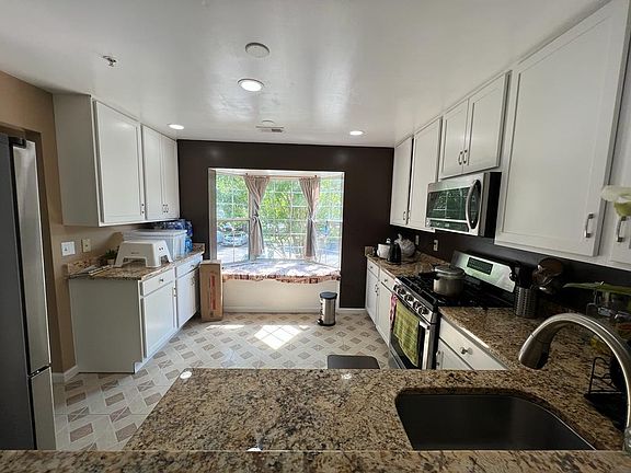 Updated kitchen cabinets with window seat and storage.