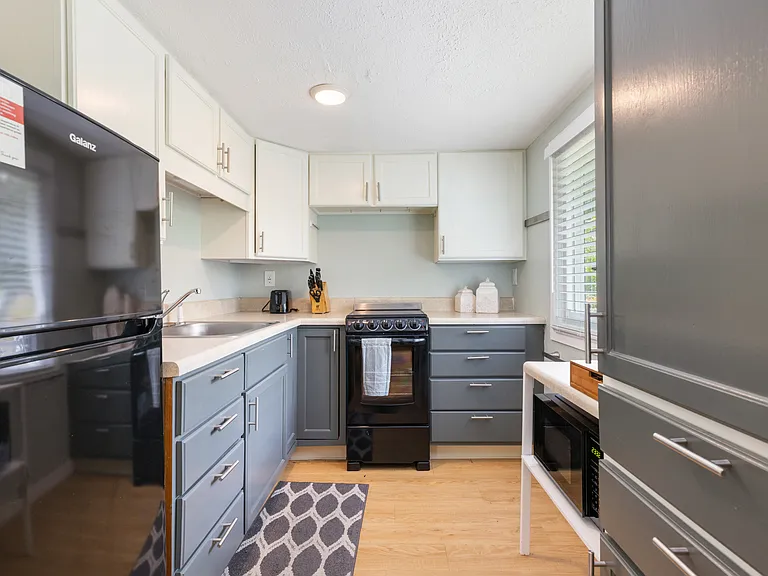 Full updated kitchen equipped with apartment-sized oven/stove and refrigerator_ready for all your cooking needs.