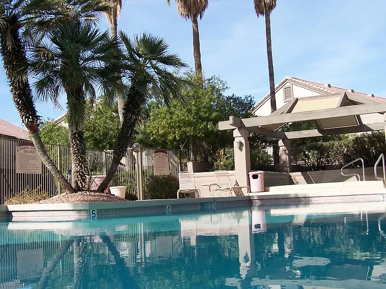 View of large pool with extra large jacuzzi at rear of pictu