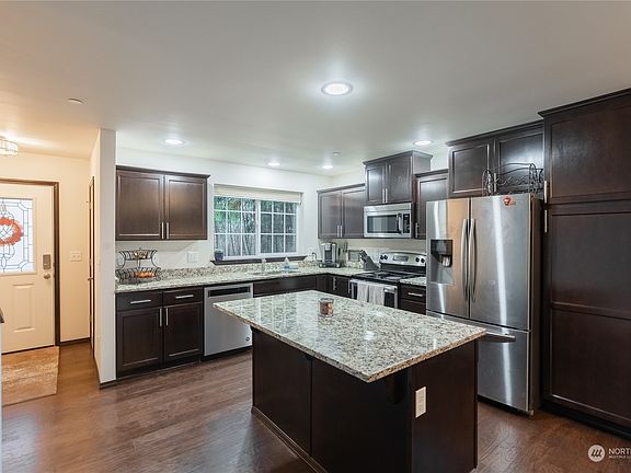 Entry has coat closet and view into open kitchen...welcoming you home>
