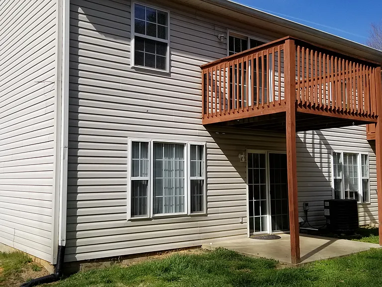 END UNIT. VIEW OF BACK PATIO AND UPPER BALCONY ATTACHED TO MASTER BEDROOM