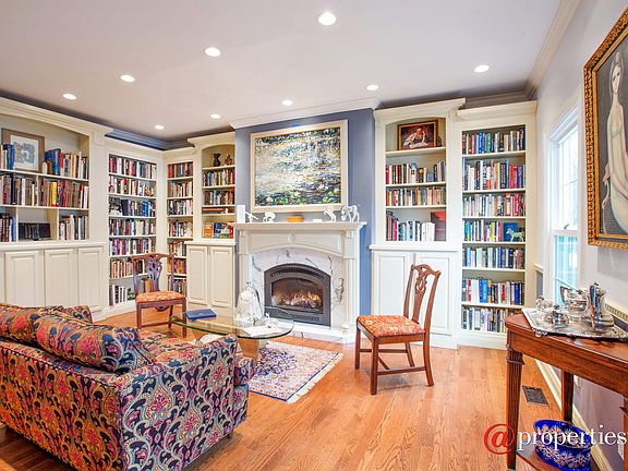 Living Room with custom built-ins; fireplace, hard