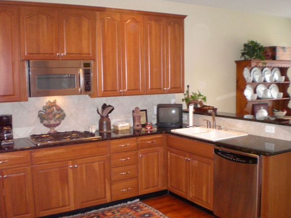 Bright, Modern Kitchen with double sink, granite countertops, hardwood floors.