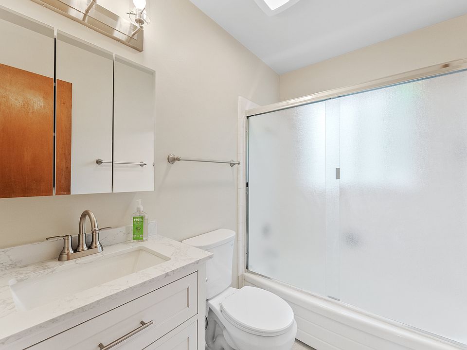 Bathroom includes new vanity, great lighting, and shower/tub combo.