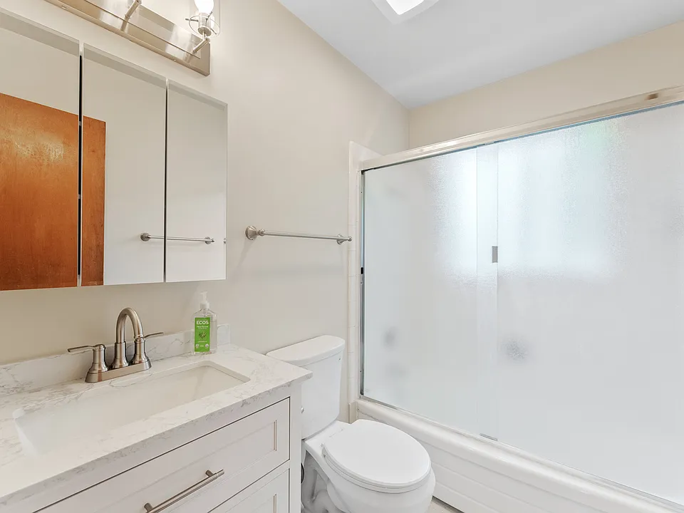 Bathroom includes new vanity, great lighting, and shower/tub combo.
