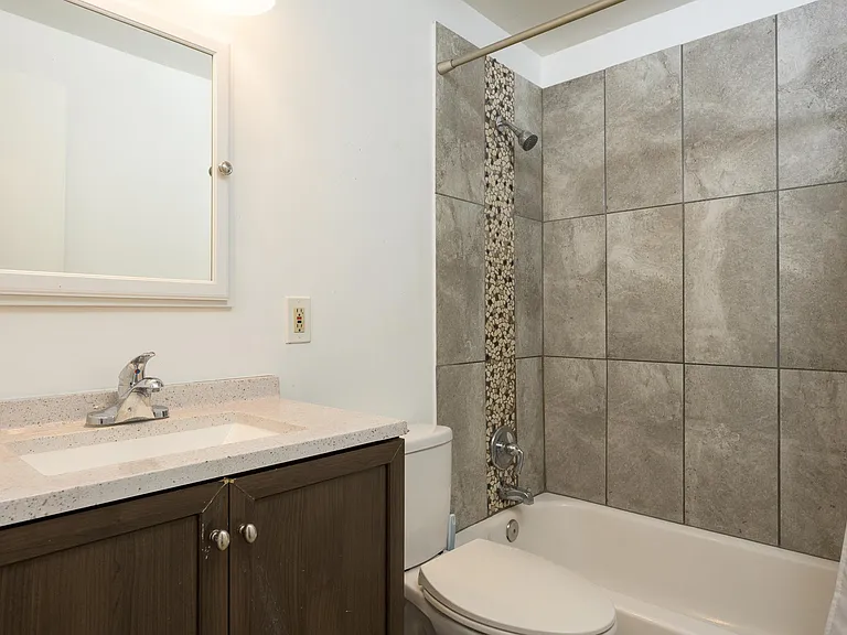 Shared medicine cabinet, adequate vanity space, large shower, toilet, and outlets!