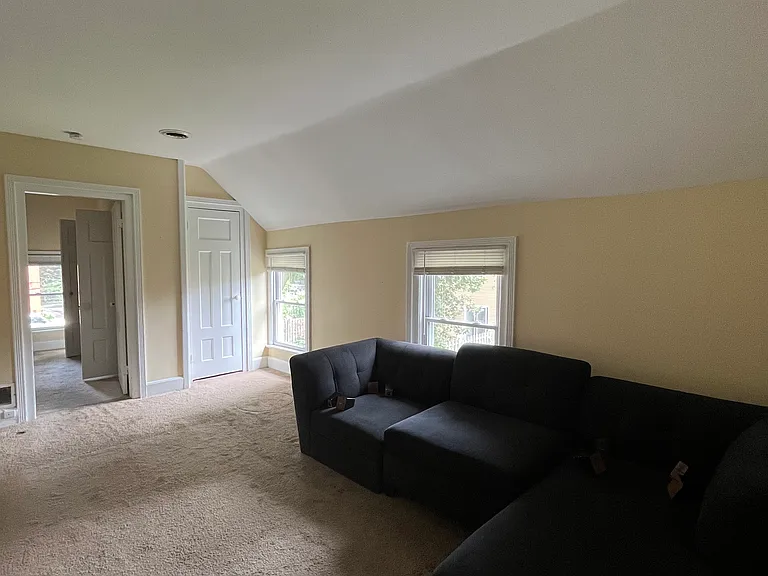 Other view of living room with bedroom entrance and additional closet.