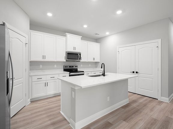 The kitchen has a large island ready to be the heart of your home