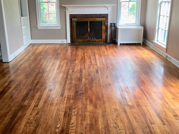 Large living room with lots of natural light and a wood burning fireplace